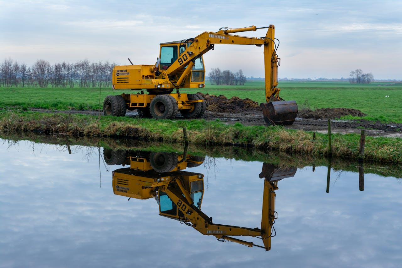 An Excavator Digging on a Field